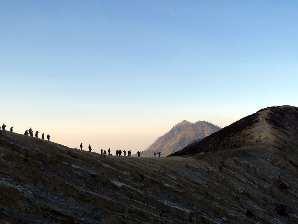 Pendaki berjalan di jalur Kawah Ijen dengan kondisi kabut tebal